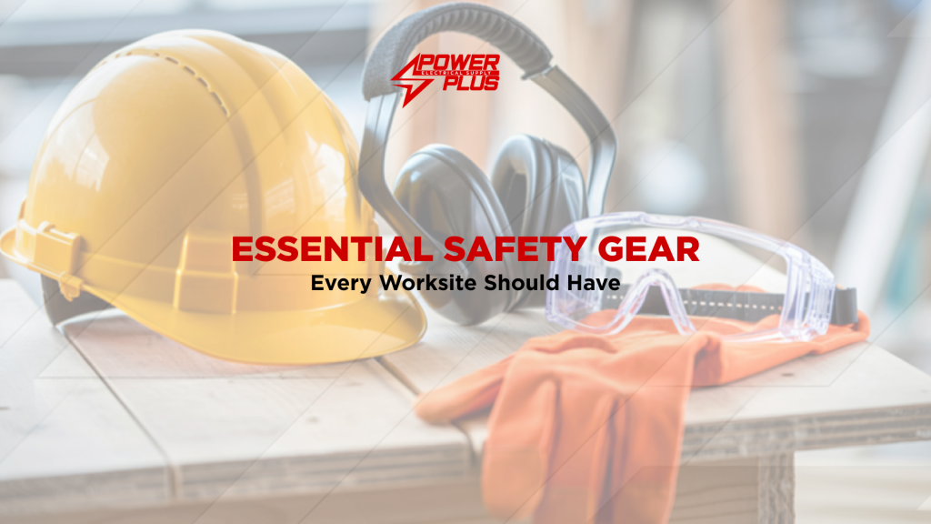 Personal protective equipment including hard hat, safety goggles, ear protection, and gloves on a worksite table